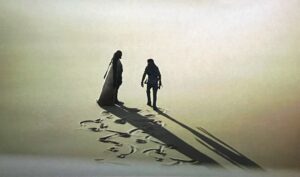 Dwie dorosłe postaci idące po piasku i rzucające długie ciemne cienie