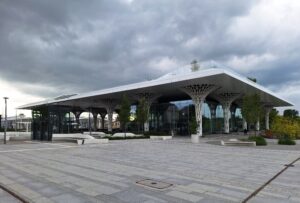 Budynek Dworca Metropolitalnego w Lublinie otoczony betonowym placem z pojedynczymi drzewkami umieszonymi w donicach